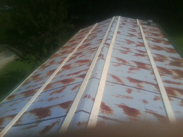 Rusted metal roof panels with new wood purlins before replacement — Storm Damage Roof Repair in Woodbury Heights by Roofing Brothers
