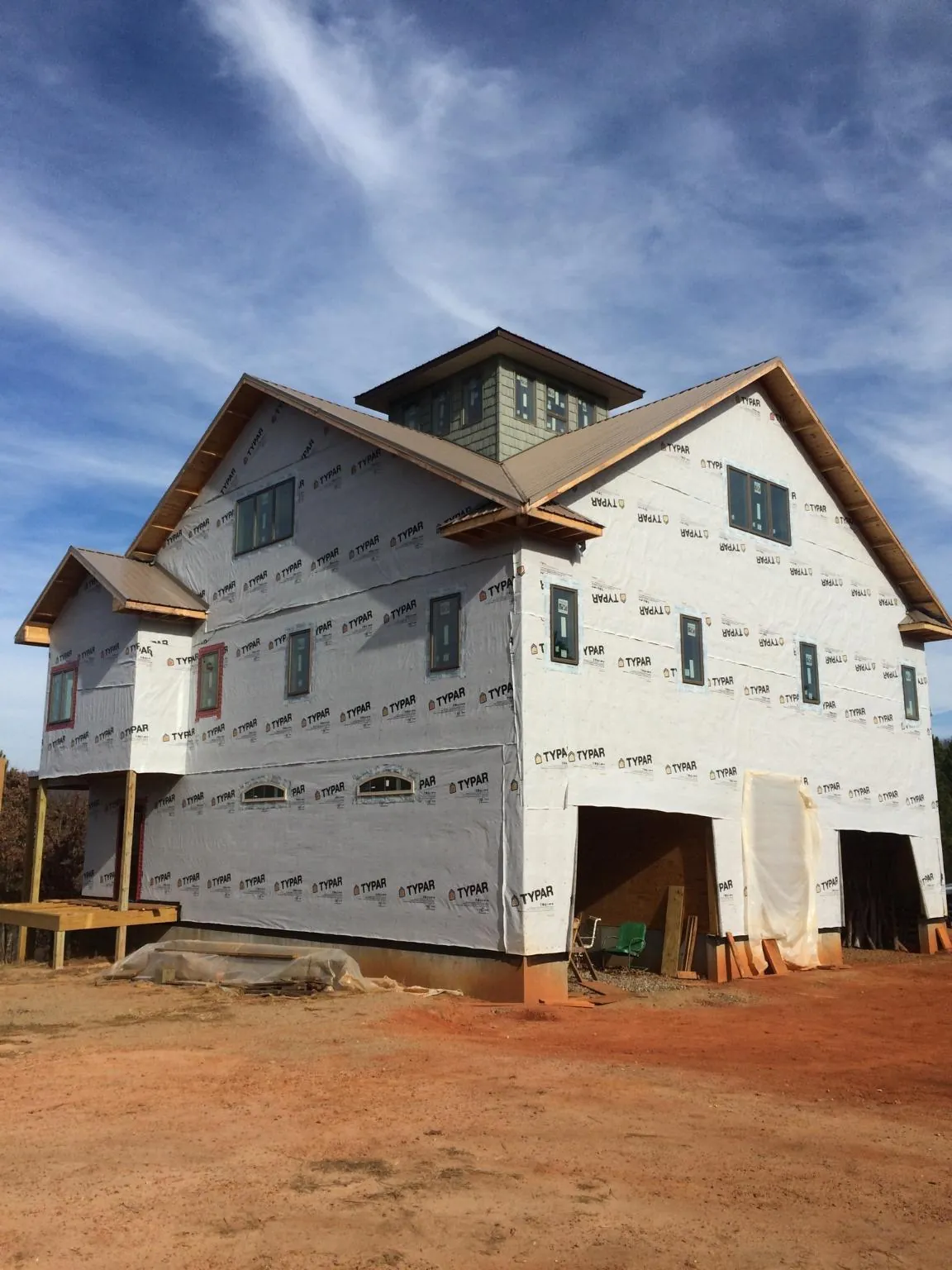 New two story house under construction with a cupola and gabled roofs in Woodbury Heights